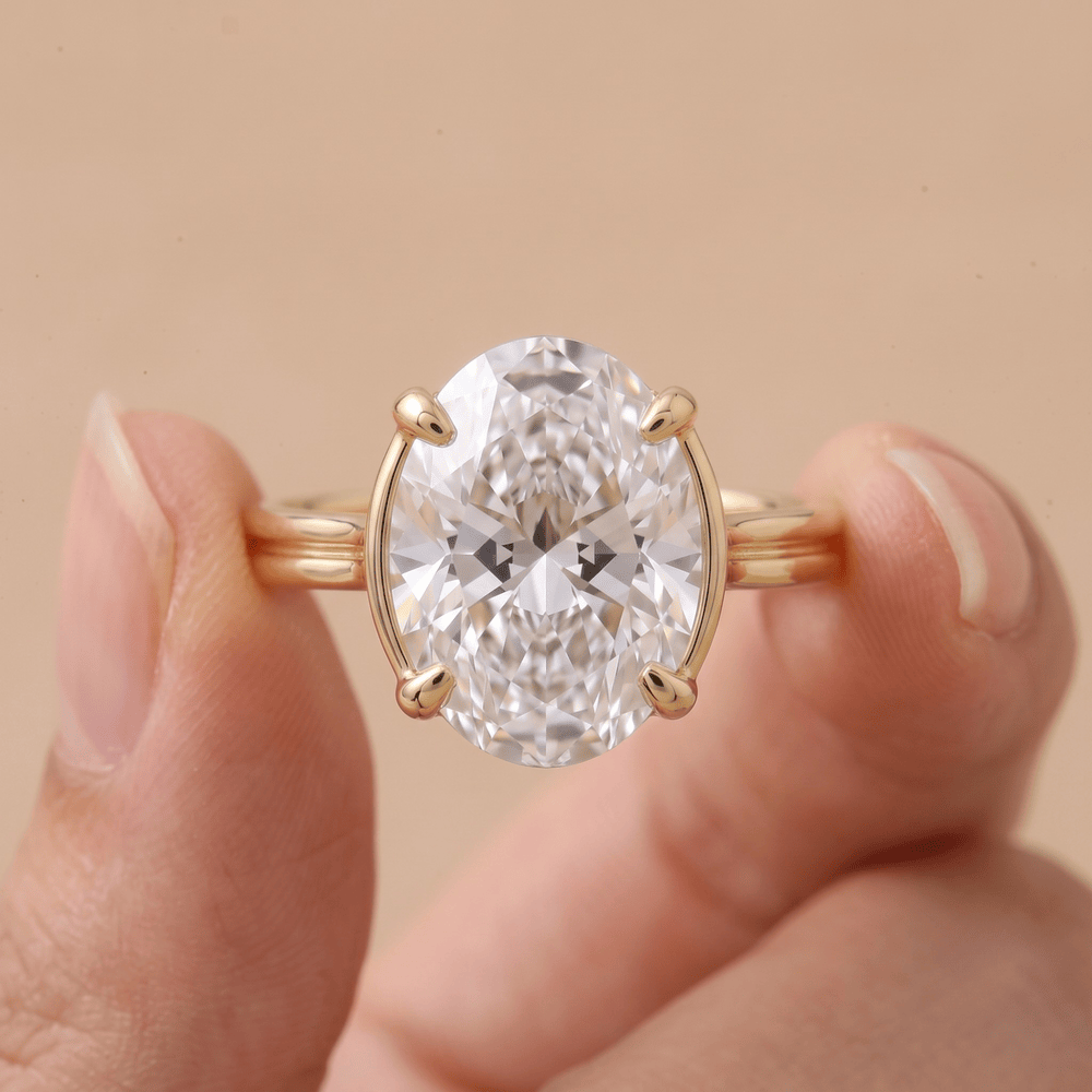 Oval moissanite celestial ring modeled on hand – 18K gold band