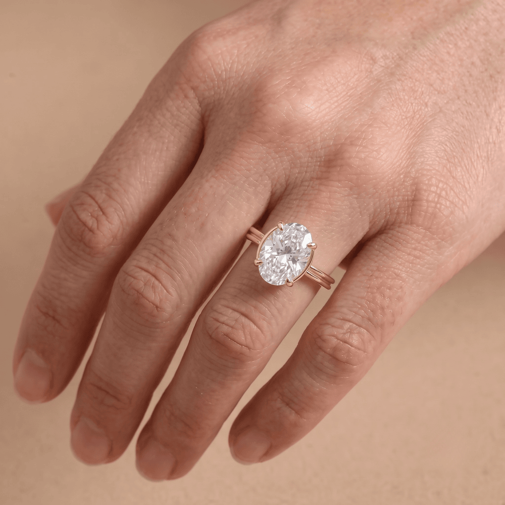 Oval moissanite celestial ring modeled on hand – 18K gold band on Finger