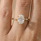 Dainty gold engagement ring with oval moissanite stone