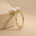 Thin gold wedding band with oval moissanite center stone