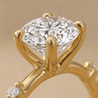 Dainty gold engagement ring with oval moissanite stone