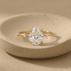 Oval moissanite gold engagement ring with dainty wedding band