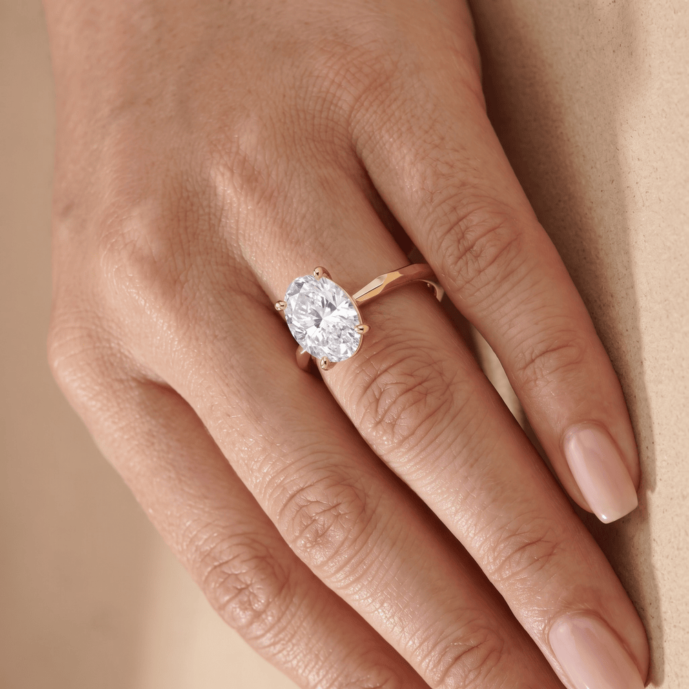 Simple gold band with oval moissanite center stone