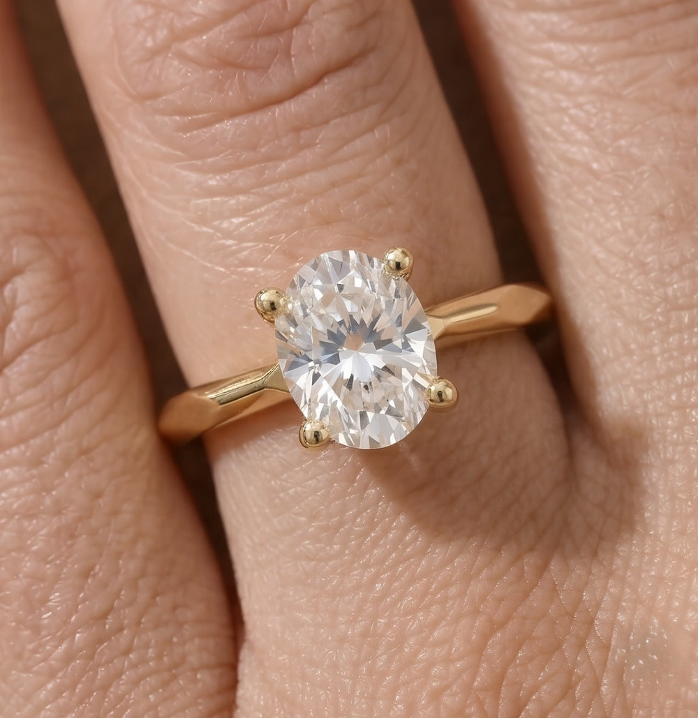Simple gold solitaire ring with oval moissanite