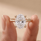 Oval moissanite solitaire ring in simple gold band
