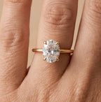 Oval moissanite bridal ring on hand