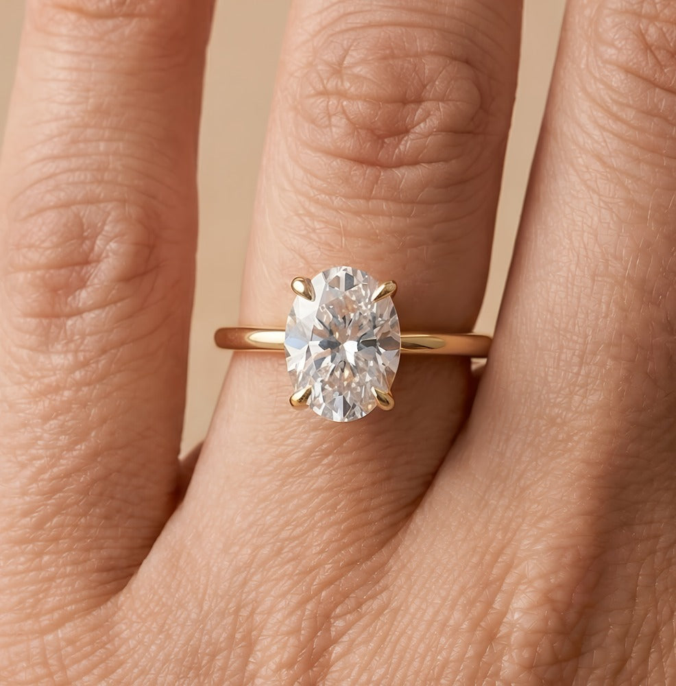 Oval moissanite bridal ring on hand