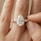 Pear cut diamond ring with side stones in yellow gold