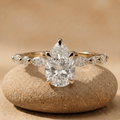 Pear cut lab diamond bridal ring in 14K gold with side stones