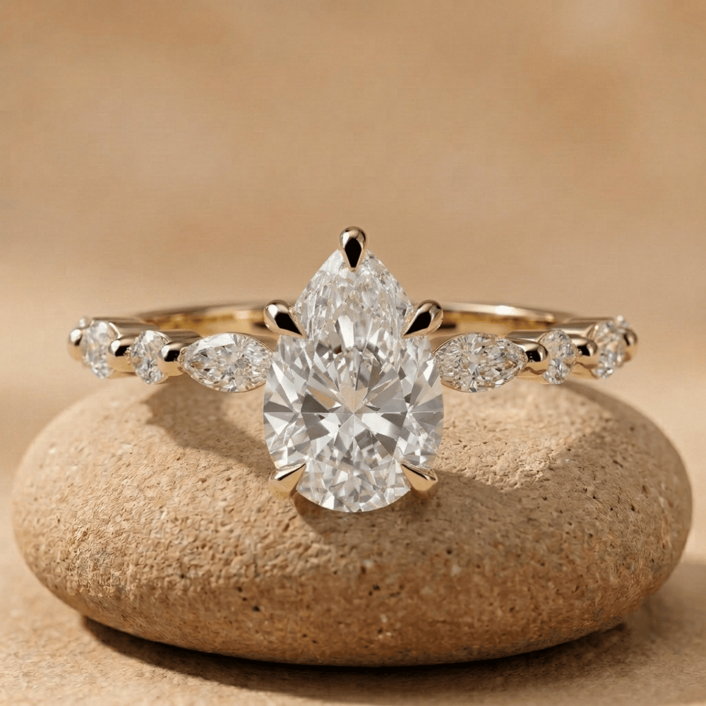 Pear cut lab diamond bridal ring in 14K gold with side stones