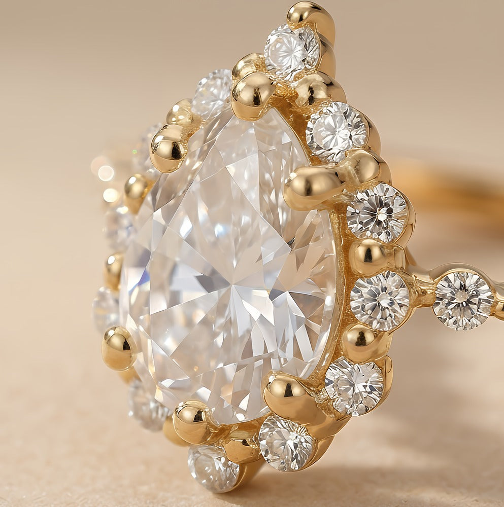 14K gold shared prong ring with pear diamond