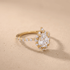 Pear shape engagement ring with shared prong band