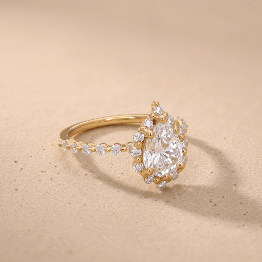 Pear shape engagement ring with shared prong band