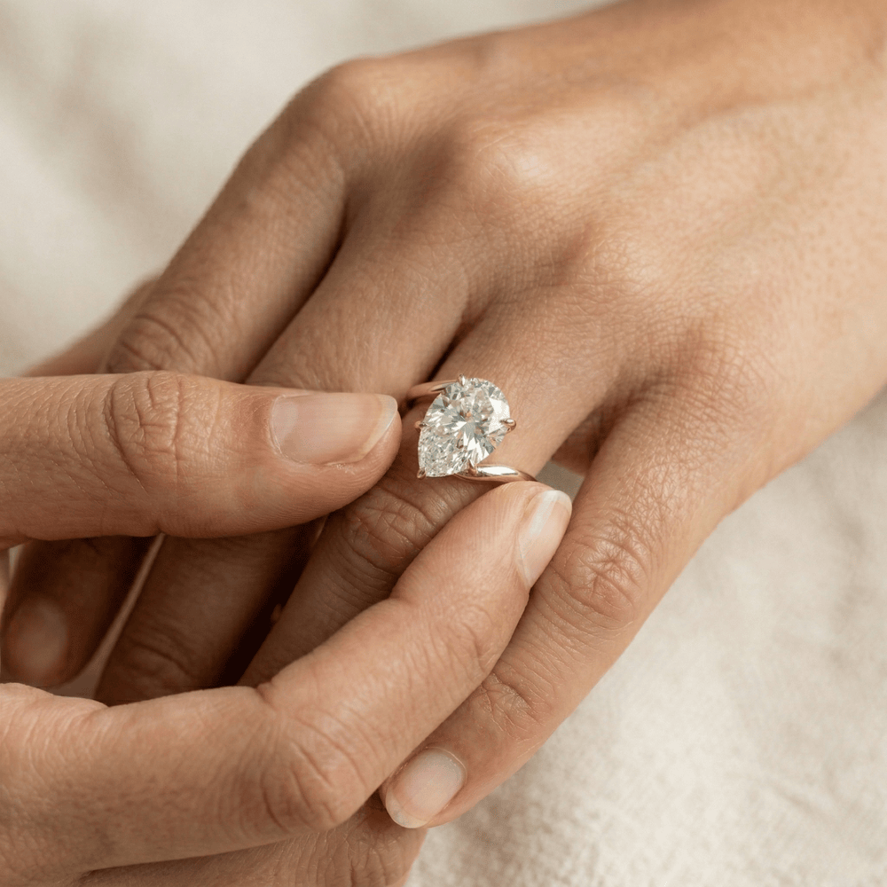 Minimalist pear solitaire bypass ring for wedding proposal