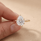 Pear cut diamond engagement ring on model's hand