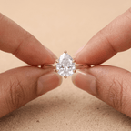 Pear cut diamond engagement ring on model's hand