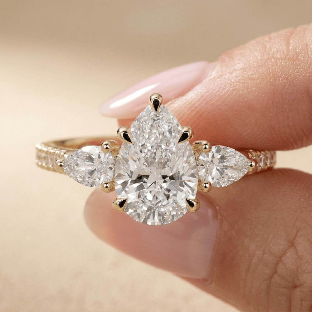 Cathedral setting pear diamond ring with pavé accents