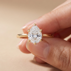 Hidden halo pear cut diamond cathedral engagement ring
