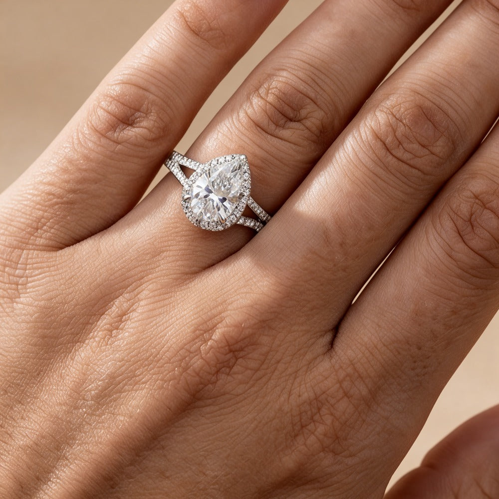 Pear cut diamond hidden halo ring on hand