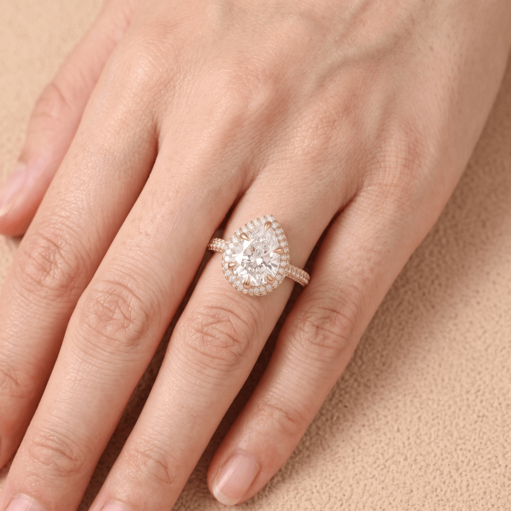 Pear shaped promise ring on model's finger
