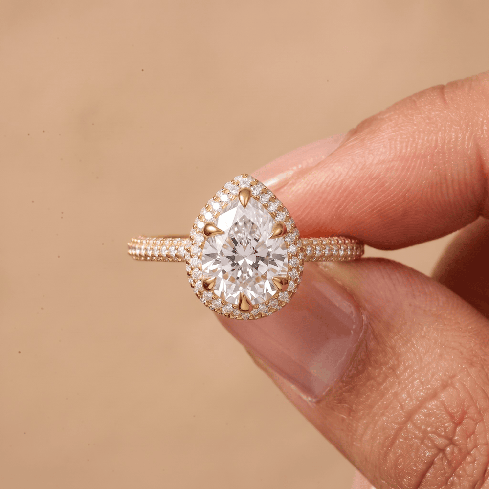 14K gold pear halo promise ring on hand