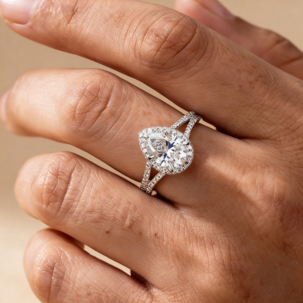 Hidden halo pear shape moissanite ring on hand