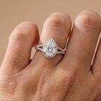 Hidden halo pear shape moissanite ring on hand