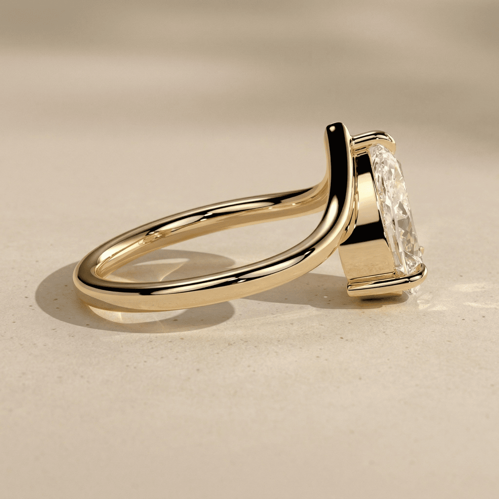 Elegant pear cut lab diamond bridal ring with curved band side angle