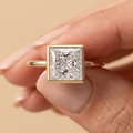 Princess bezel diamond ring worn on hand