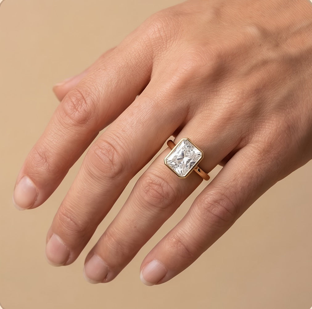 Radiant bezel anniversary ring worn on hand