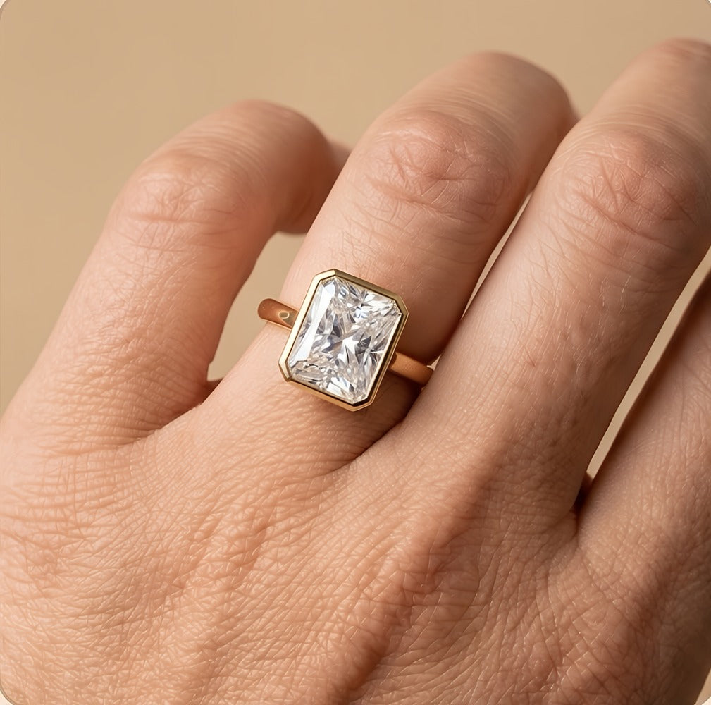 Radiant bezel anniversary ring worn on hand