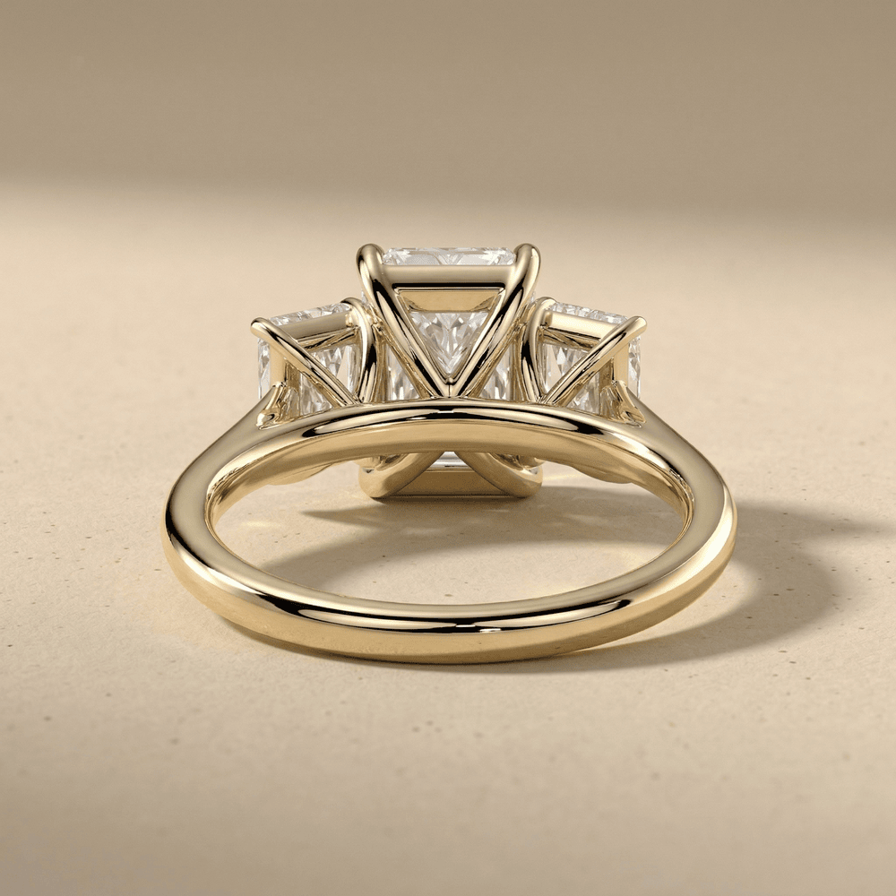 14K gold three stone engagement ring with radiant center diamond