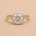 Round bezel set moissanite solitaire proposal ring front view
