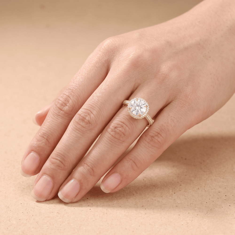 Round moissanite halo ring on model's hand
