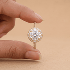 Round moissanite halo ring on model's hand