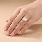 Round cut halo ring on model's hand, natural lighting