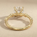 Dainty gold engagement ring with brilliant round moissanite