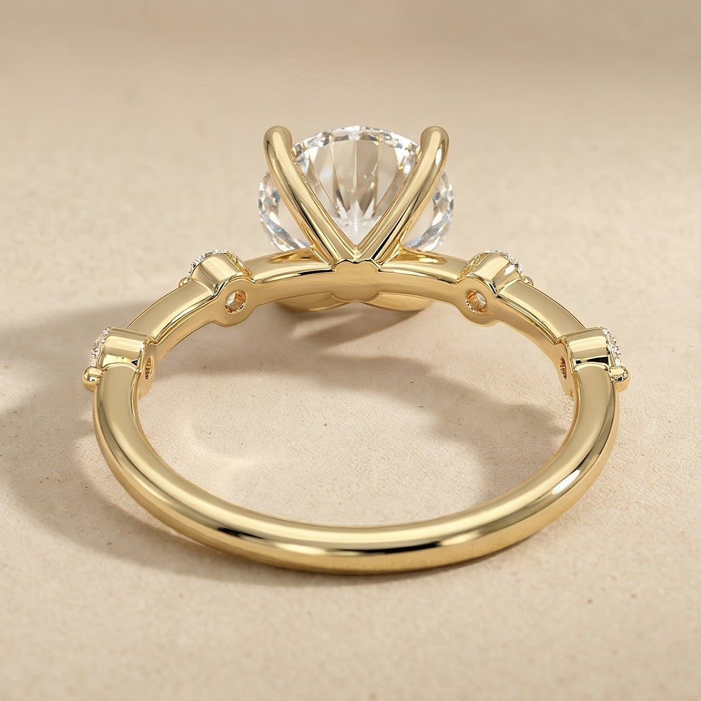 Dainty gold engagement ring with brilliant round moissanite