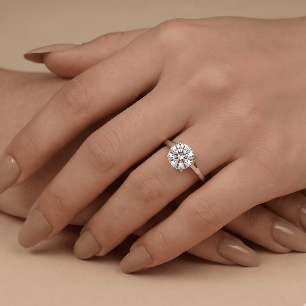 14K gold curved band ring on hand, round moissanite detail