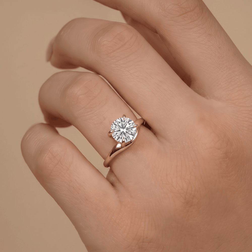 Round cut moissanite ring showcasing 14K gold curved band design