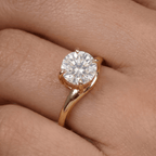 14K gold curved band ring on hand, round moissanite detail