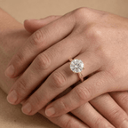 Round moissanite proposal ring with vintage detailing on finger