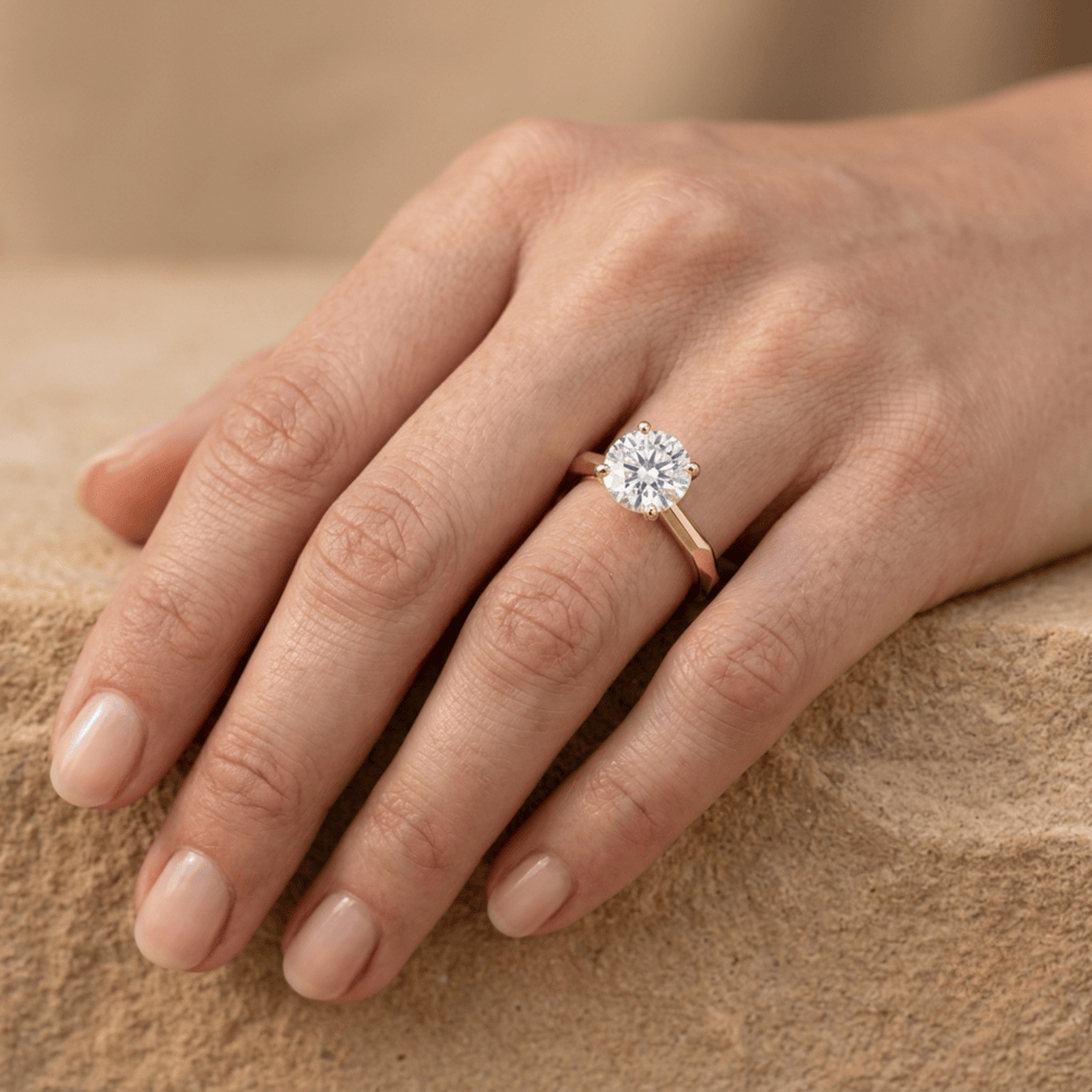 Round solitaire ring on model's hand finger view