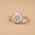 Round halo moissanite engagement ring in 14K gold