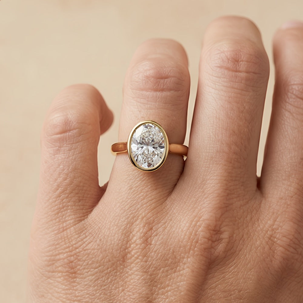 Oval solitaire bezel ring side profile view