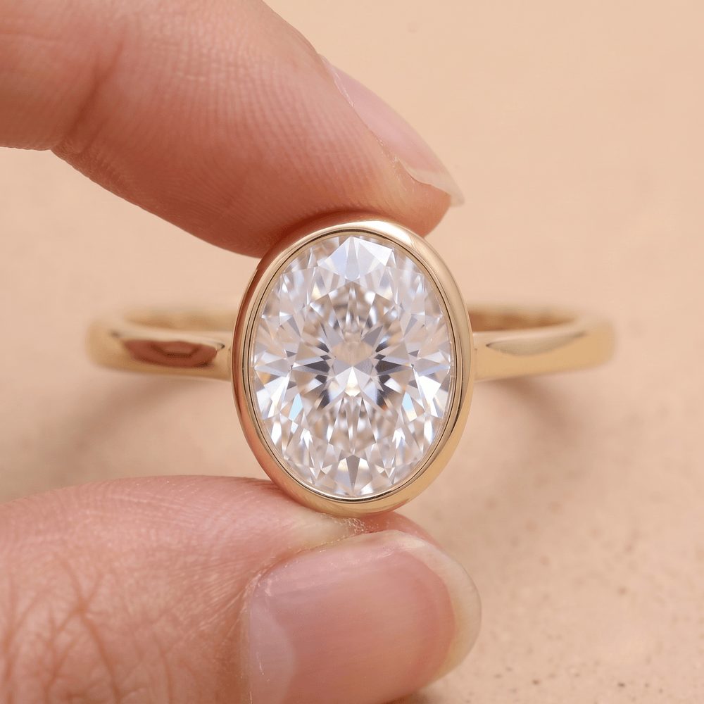 Oval solitaire bezel engagement ring front view
