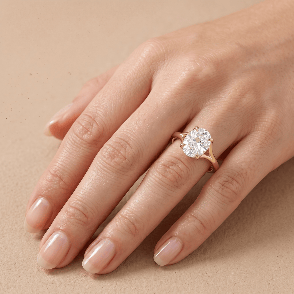 Ethically sourced solitaire oval diamond ring on model's hand