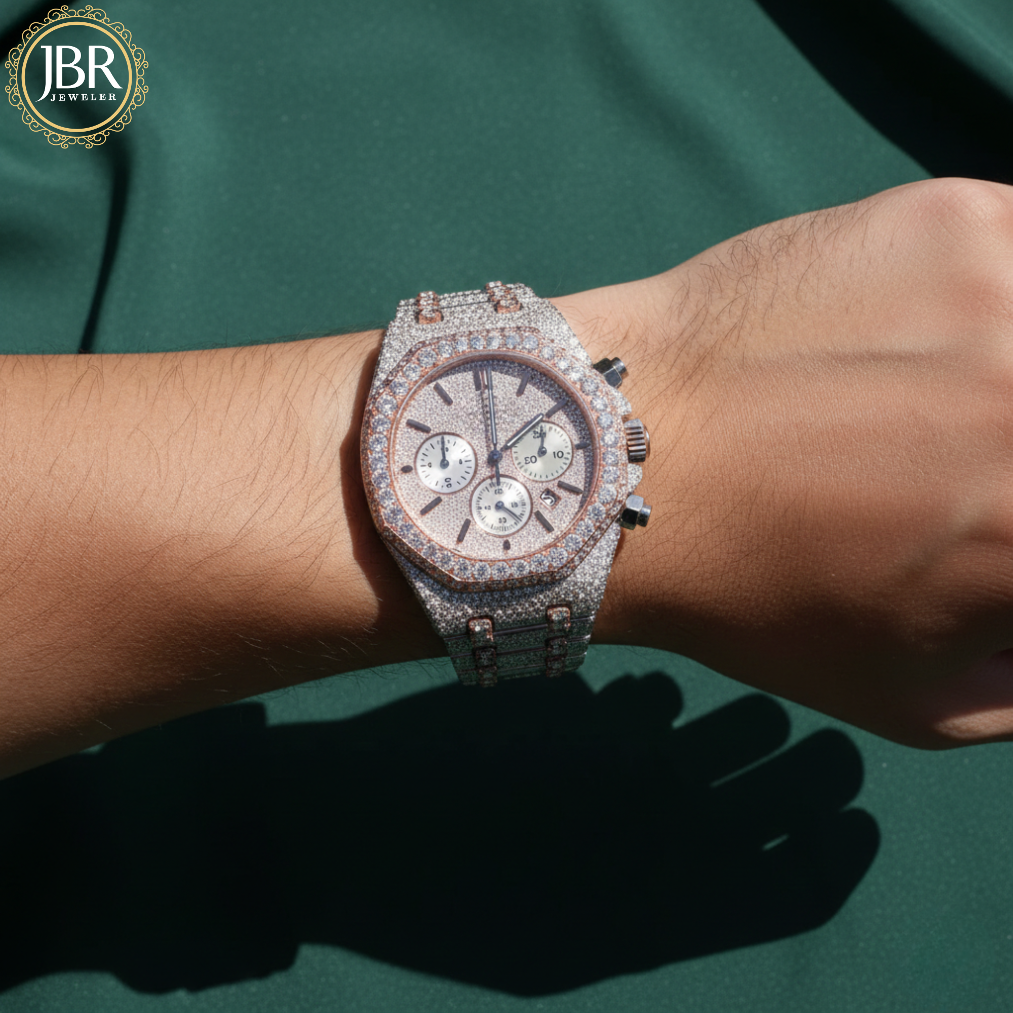 Luxury watch with diamond accents on a wrist, branded 'JBR'.