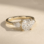 Cushion cut moissanite engagement ring with side stones