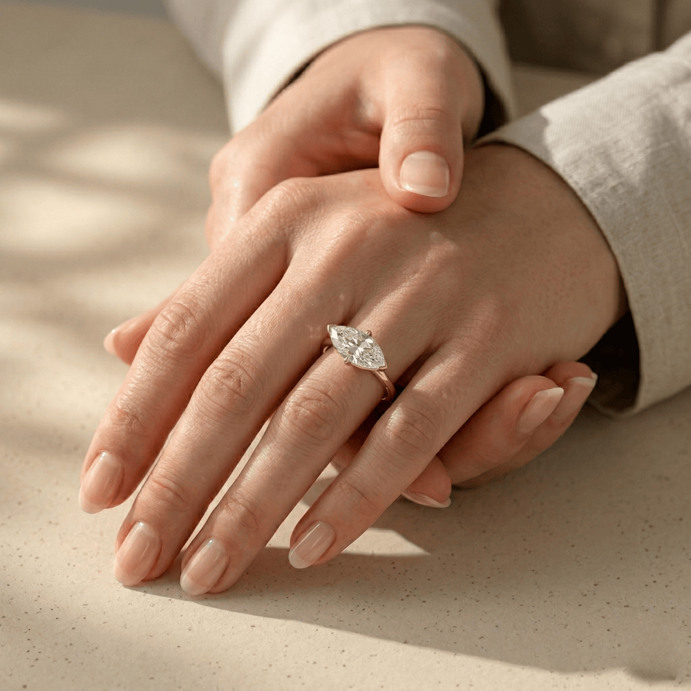 Marquise solitaire engagement ring with yellow gold band